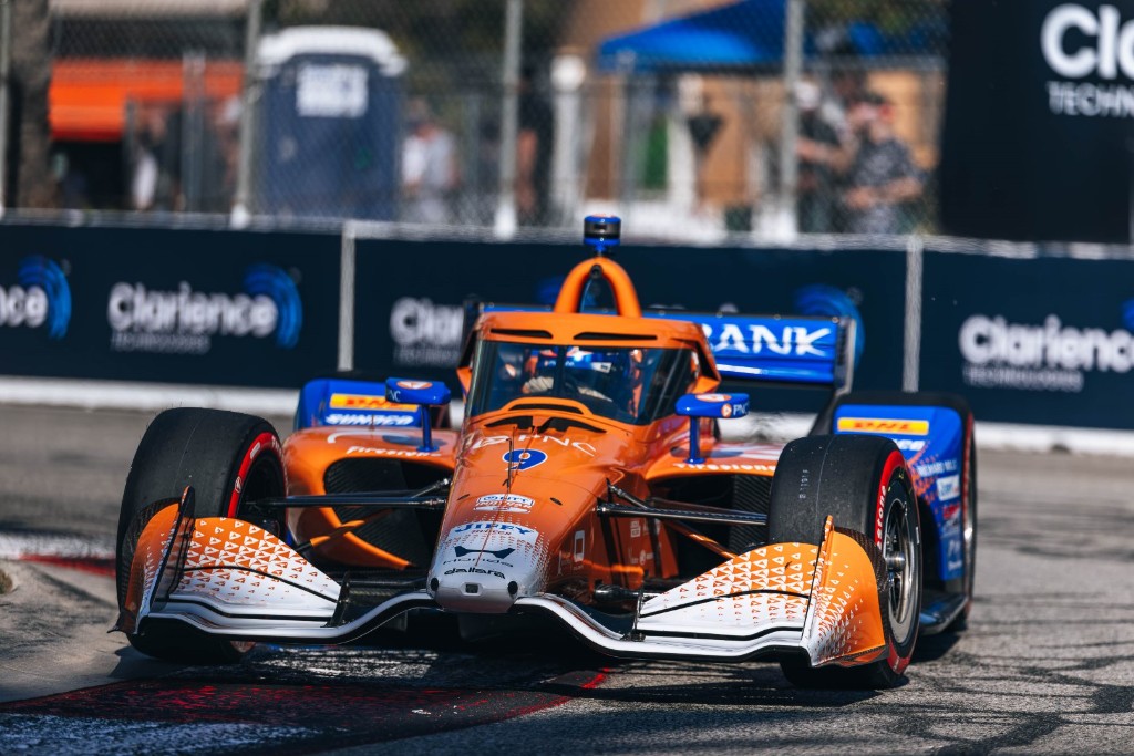 Scott Dixon driving the number 9 orange and blue PNC Bank Chip Ganassi Racing IndyCar at the Long Beach street circuit.